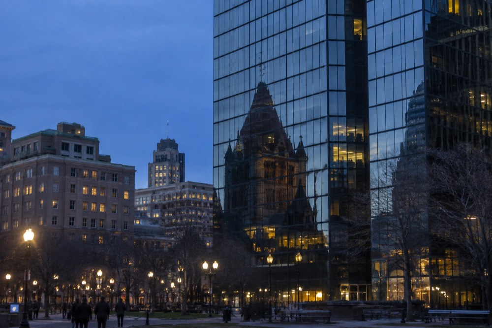 Trinity Church reflected in the mirrored glass facade of the John Hancock tower in Copley Square