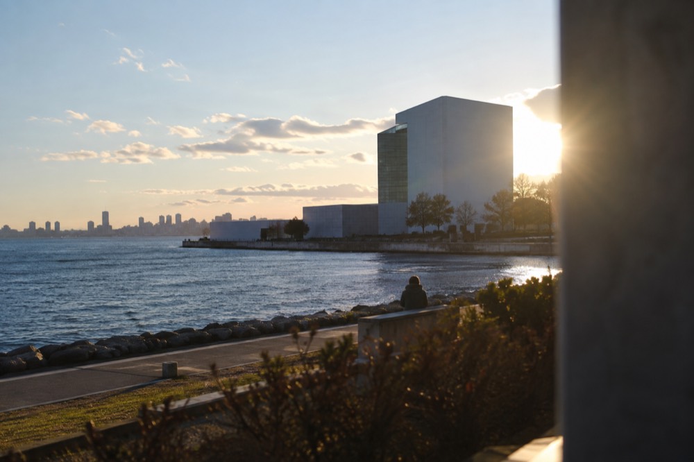 The white tower of the JFK Presidential Library overlooking Dorchester Bay on a clear day