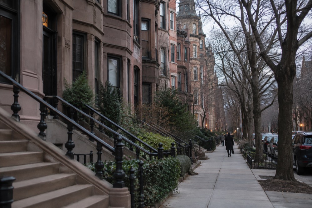 Victorian brownstone row houses on a tree-lined Back Bay street in Boston