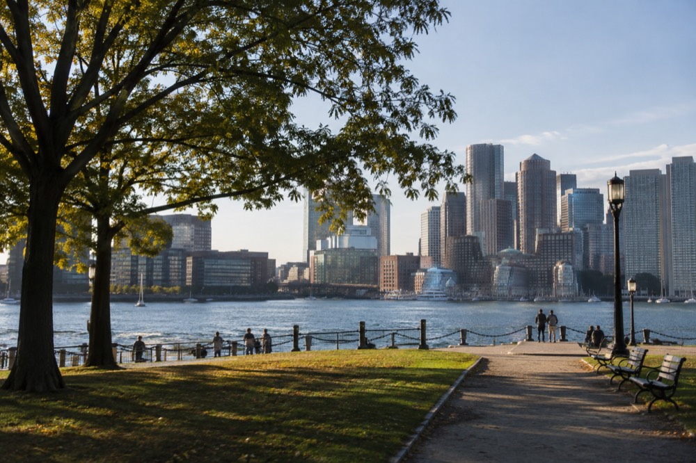 Boston's waterfront skyline with harbor water in the foreground on a clear day