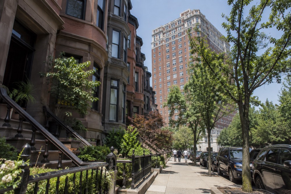 A grand brick hotel tower rising over a tree-lined Back Bay street in Boston