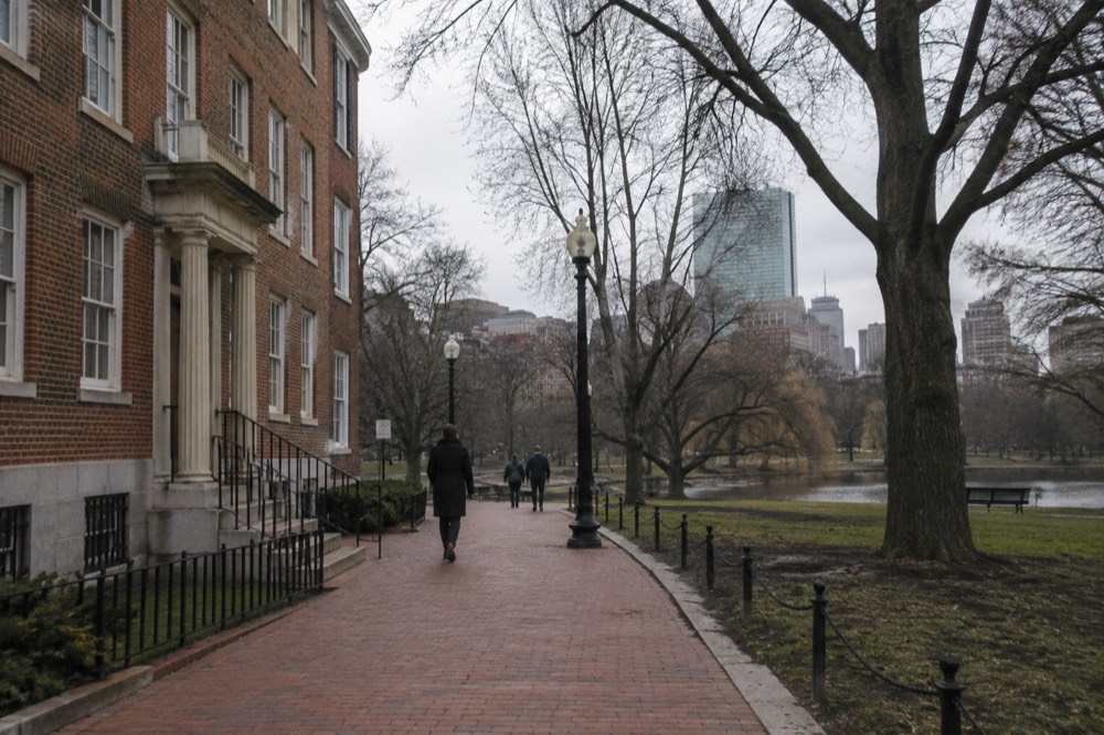 A red brick lane in Boston passing a historic colonial-era building