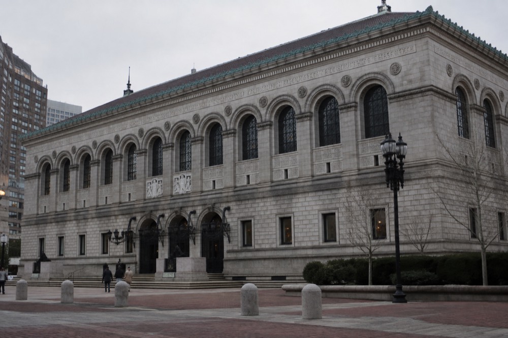 The grand stone facade of the Boston Public Library Central Library facing Copley Square