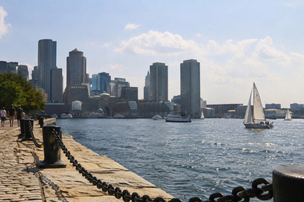 The Boston waterfront and harbor on a clear mild afternoon with boats on the water