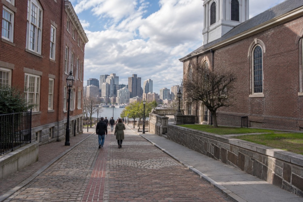 A red-lined Freedom Trail brick path passing historic Boston buildings
