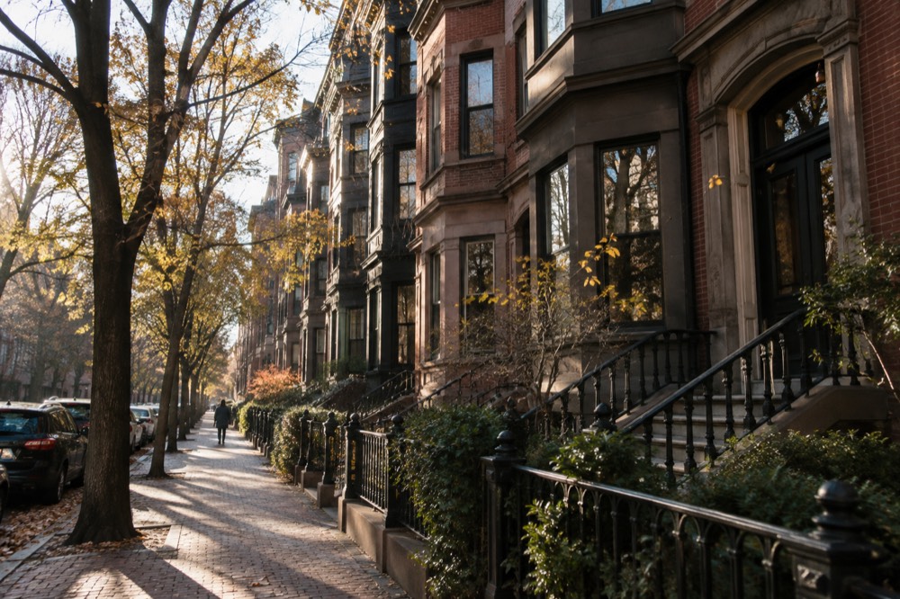Brownstone rowhouses along a tree-lined Back Bay street in Boston