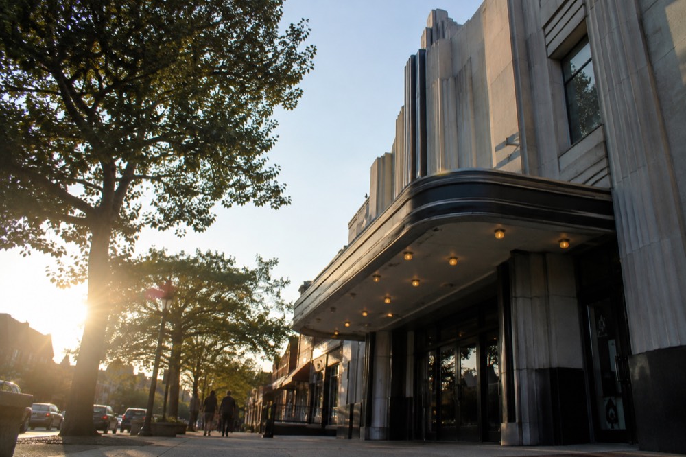 A restored Art Deco theater facade on a commercial corner in afternoon light