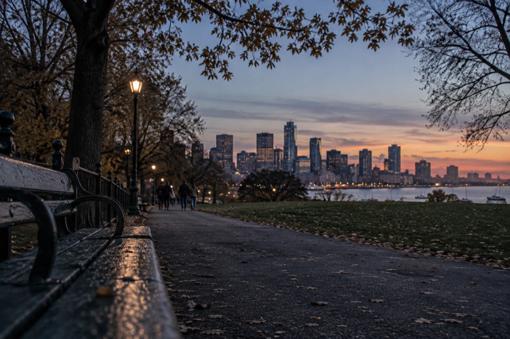Boston's skyline seen across the harbor at golden hour
