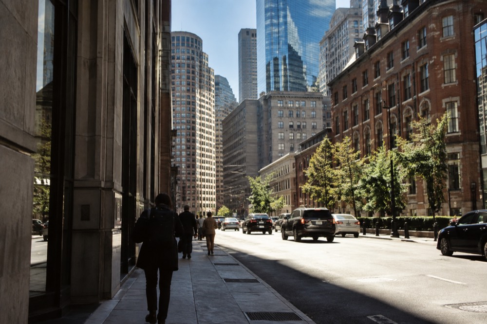 Modern glass towers of the Financial District rising over older brick buildings