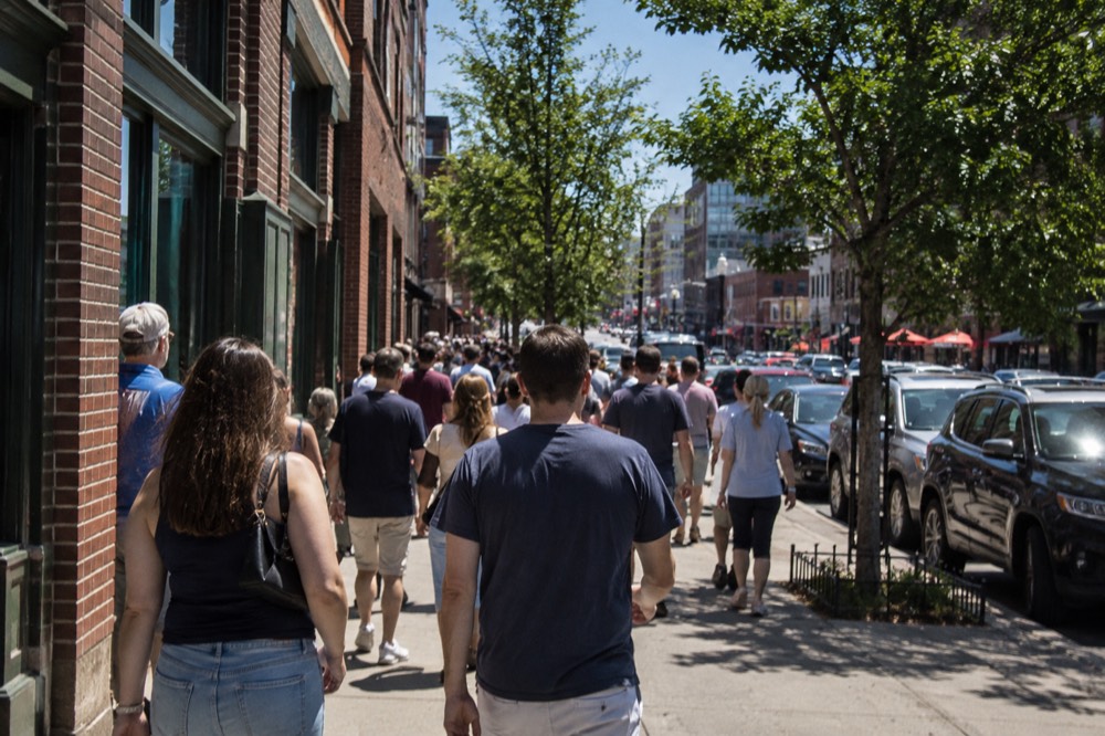 Fans fill the sidewalk outside the ballpark before an afternoon game