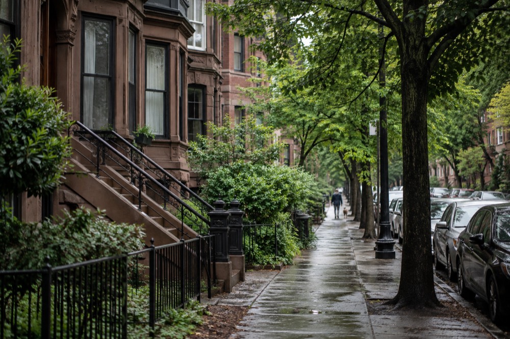 Brownstone apartment buildings on a tree-lined Fenway side street