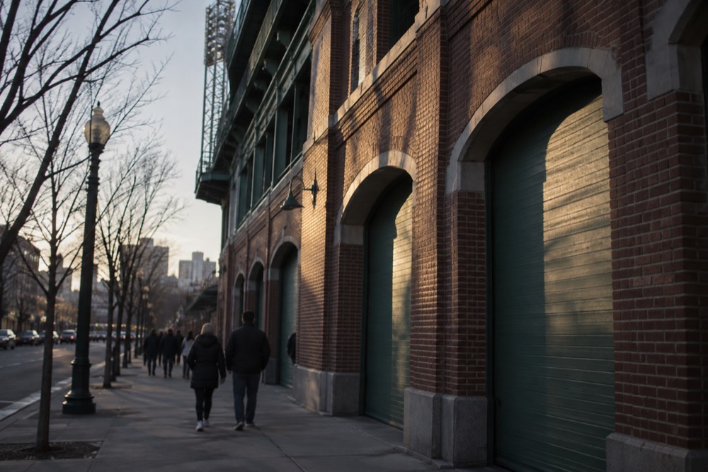 Evening light on the brick facade and arched entry of an old ballpark