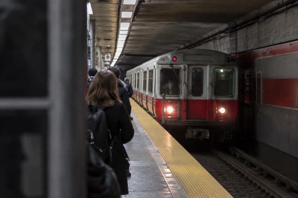 A Red Line train arriving at an underground Cambridge station platform