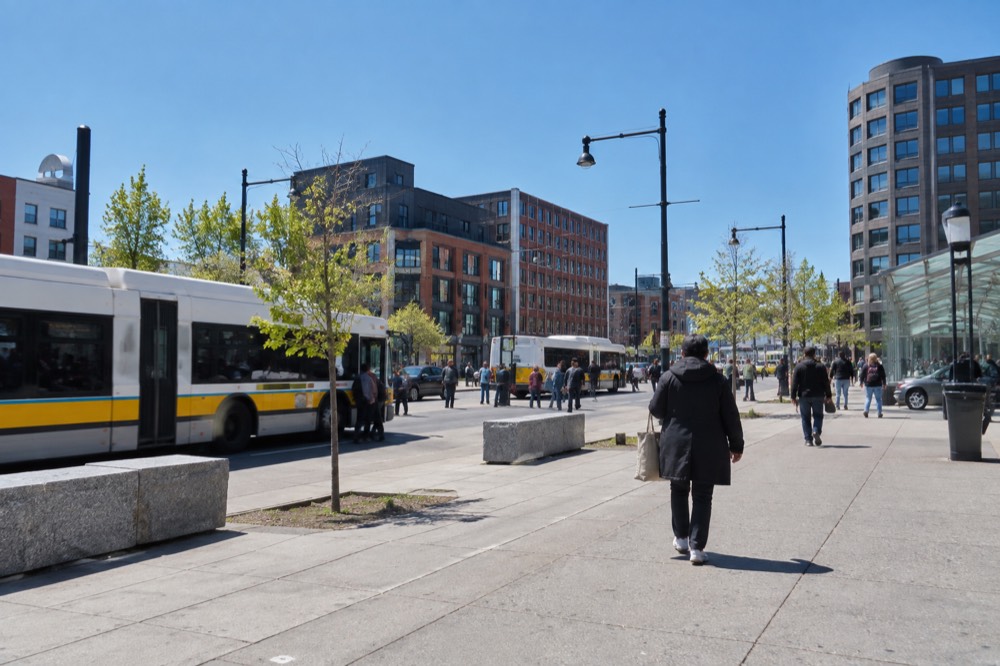 Shoppers and buses at a busy square in Roxbury