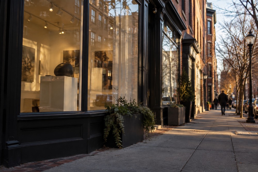 An art gallery storefront with large windows on a South End side street