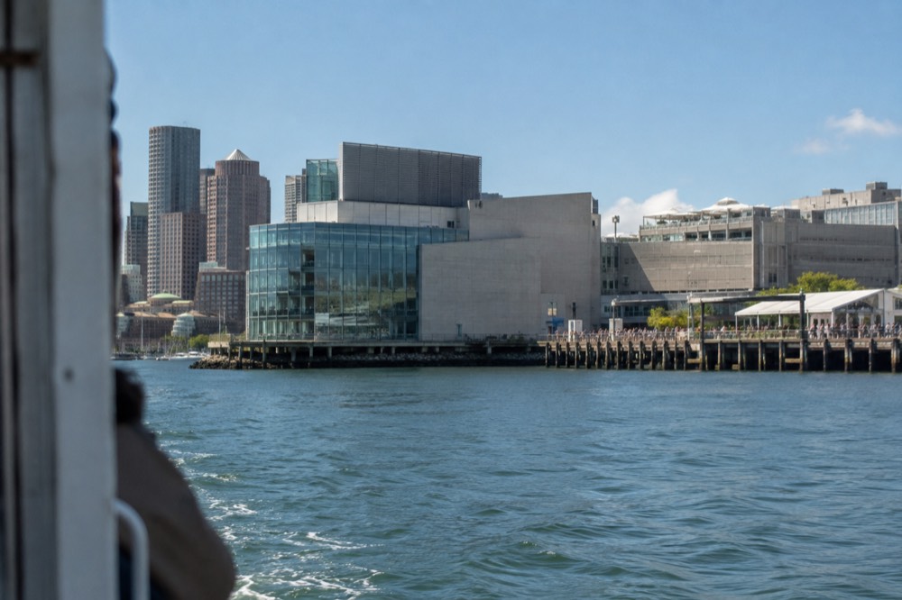 The New England Aquarium building seen from the water with Long Wharf beside it