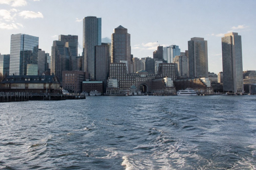 The downtown Boston waterfront skyline seen from open harbor water