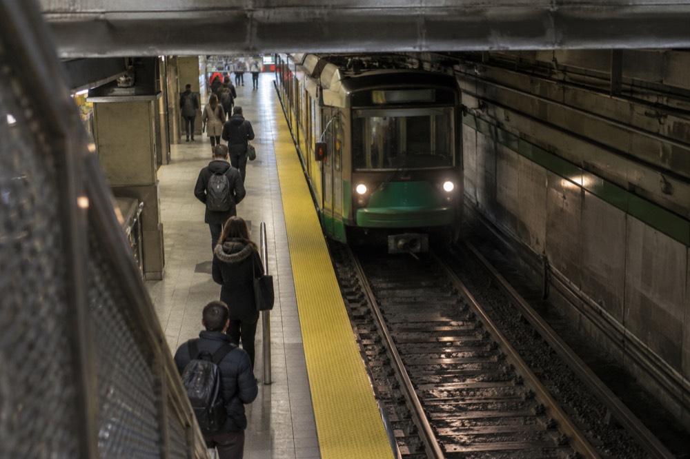A Green Line trolley arriving at an underground MBTA station platform in Boston