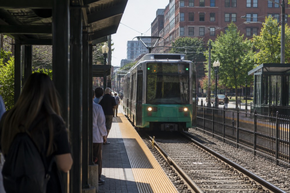 A Green Line trolley arriving at an outdoor subway station near the ballpark