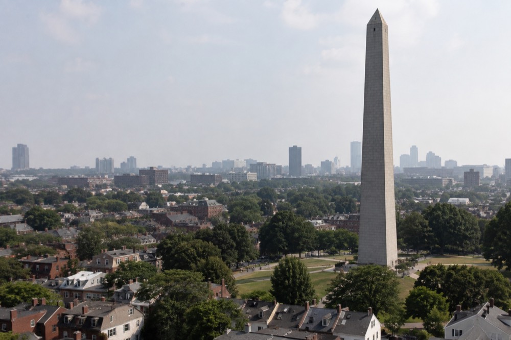 Bunker Hill Monument granite obelisk rising above Charlestown rooftops