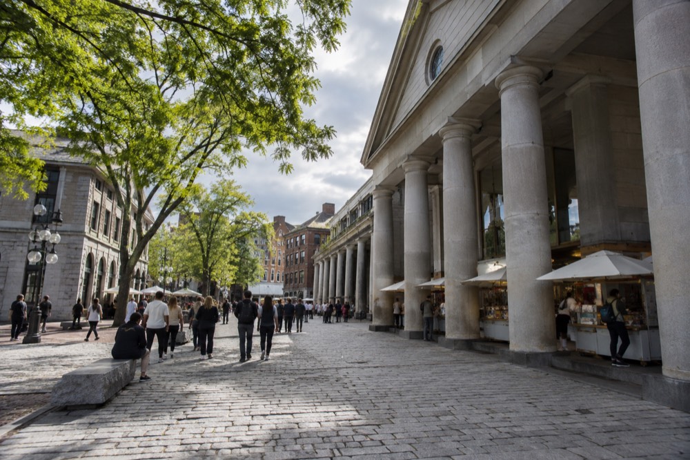 Quincy Market colonnade with food stalls and visitors at midday
