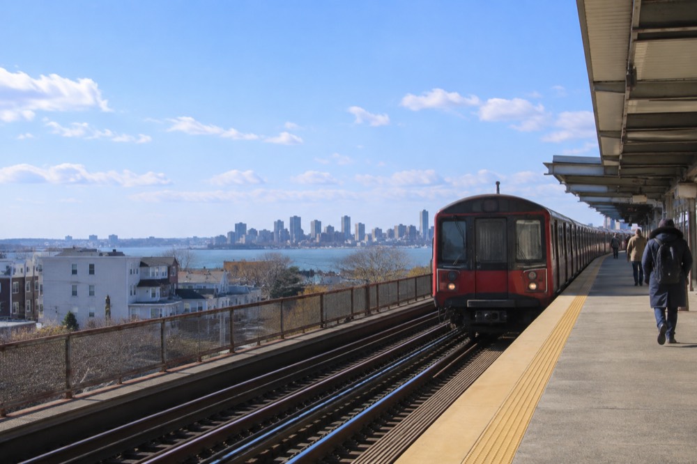 Red Line subway train arriving at an elevated Dorchester station