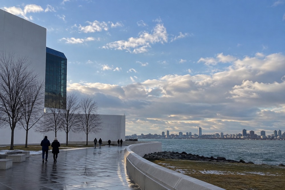 Harbor water and skyline under a partly cloudy sky in winter light