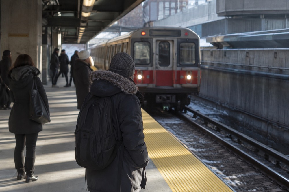 Red Line subway platform at Kendall station with a train arriving