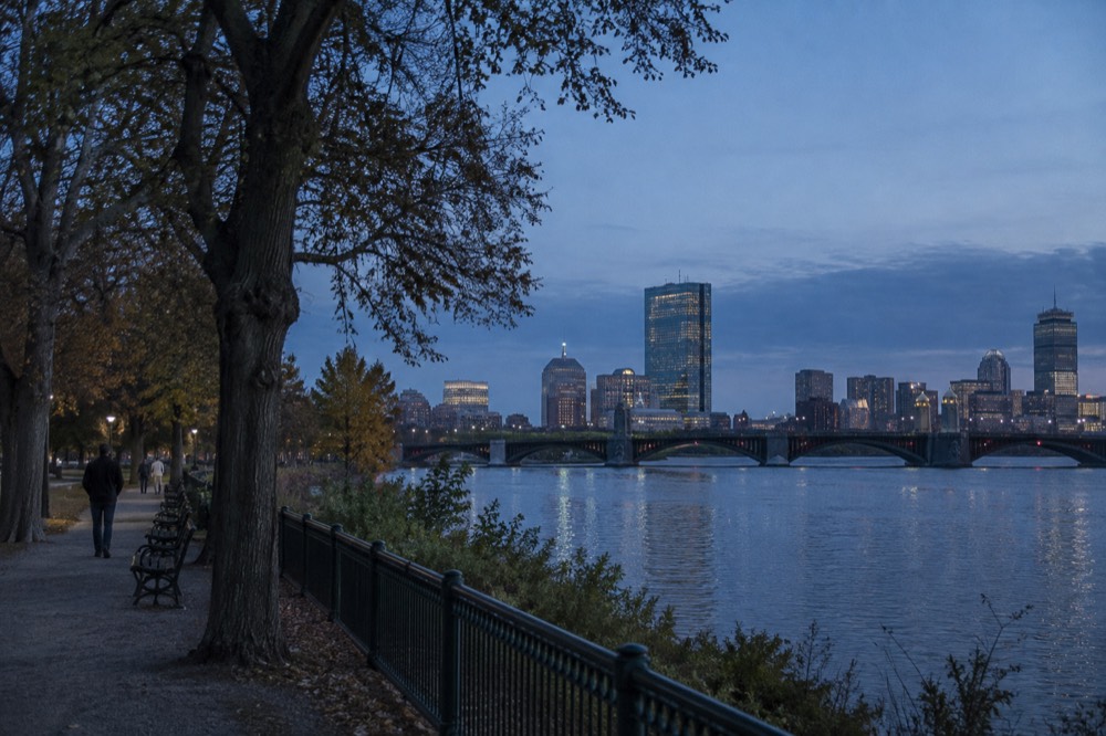 Evening view of the Longfellow Bridge and Boston skyline from the Cambridge riverbank