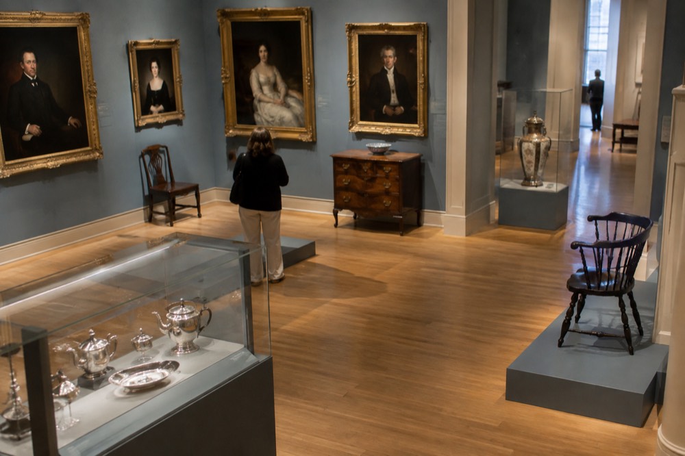 A gallery of colonial-era portraits and decorative arts in a wing of the museum