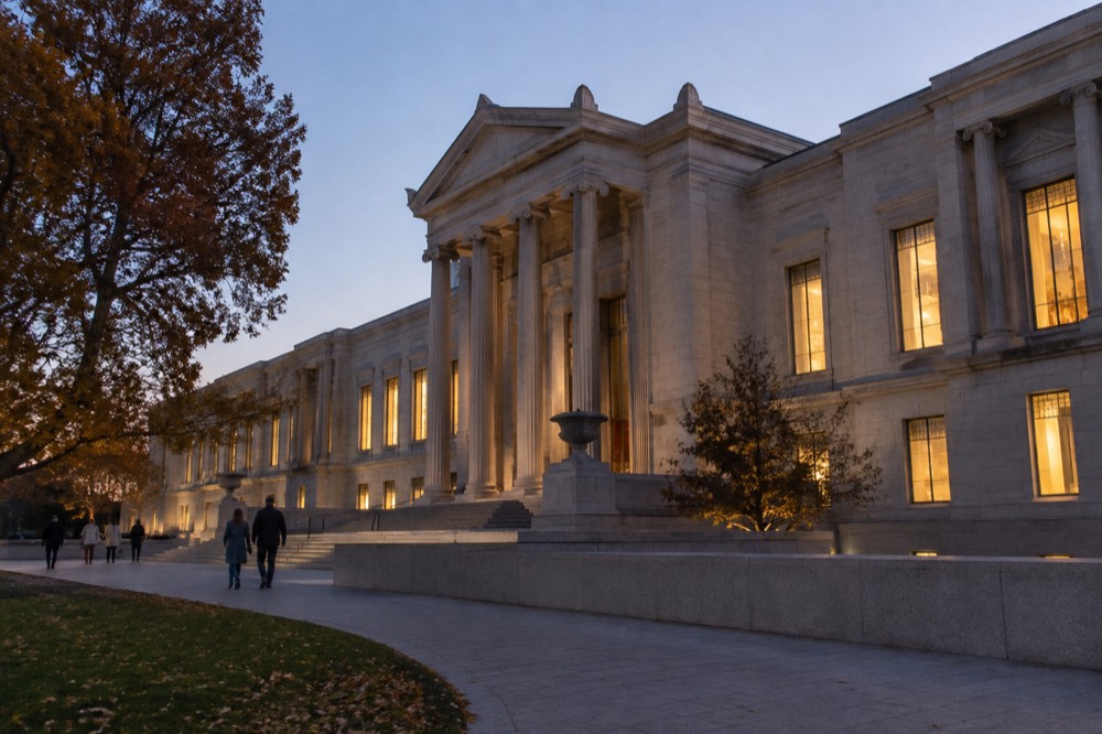 The exterior of an art museum at dusk with lit windows