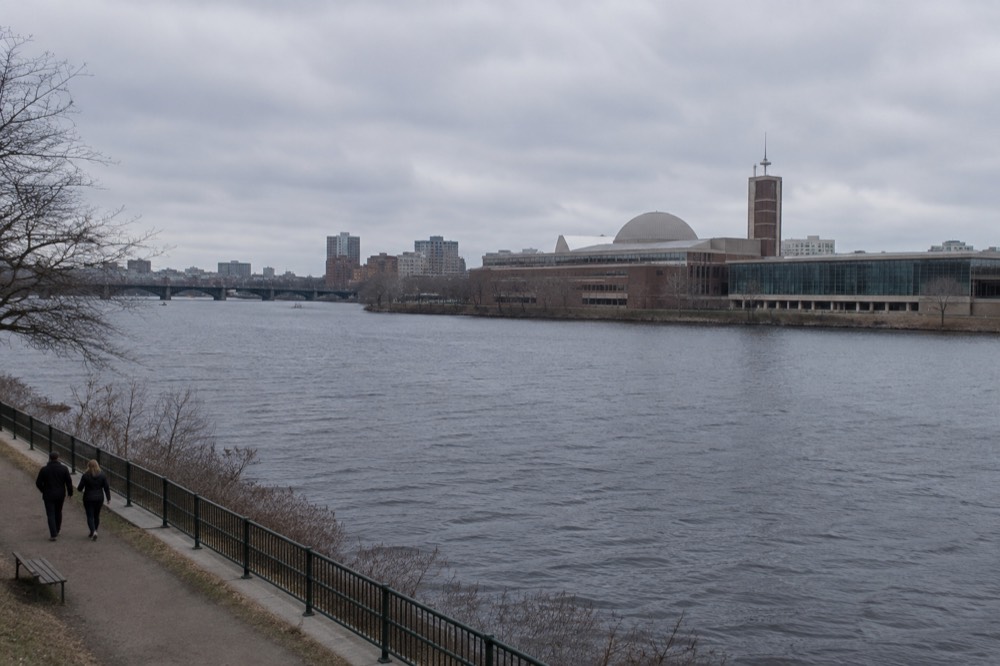 The Museum of Science building beside the Charles River with its dome and tower visible above the water