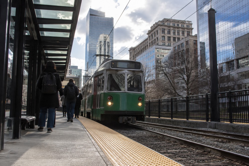 Green Line trolley arriving at an MBTA station platform in downtown Boston