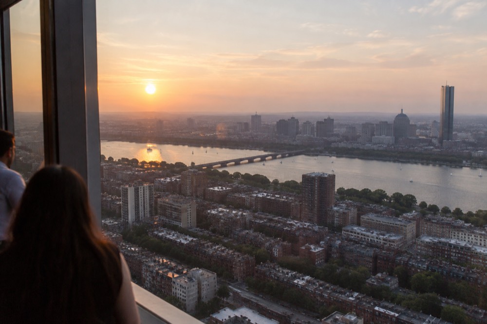 Sunset light falling across the Boston skyline as seen from a high observation window