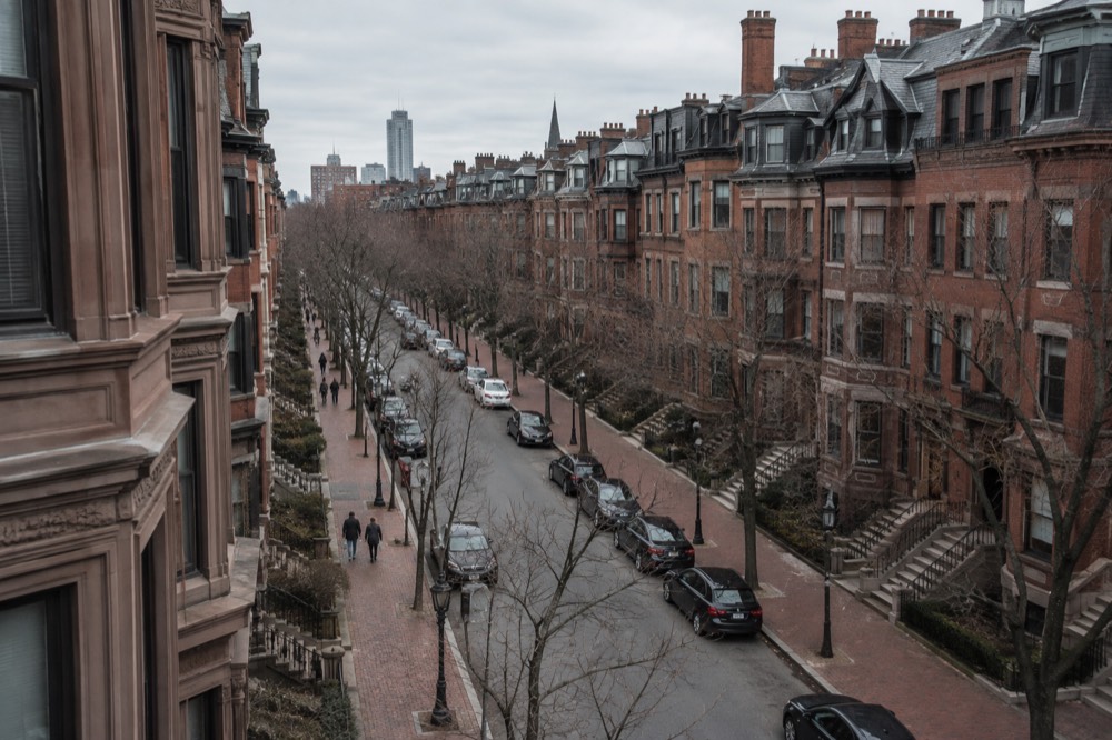 Looking down the length of a brownstone-lined Back Bay street from high above