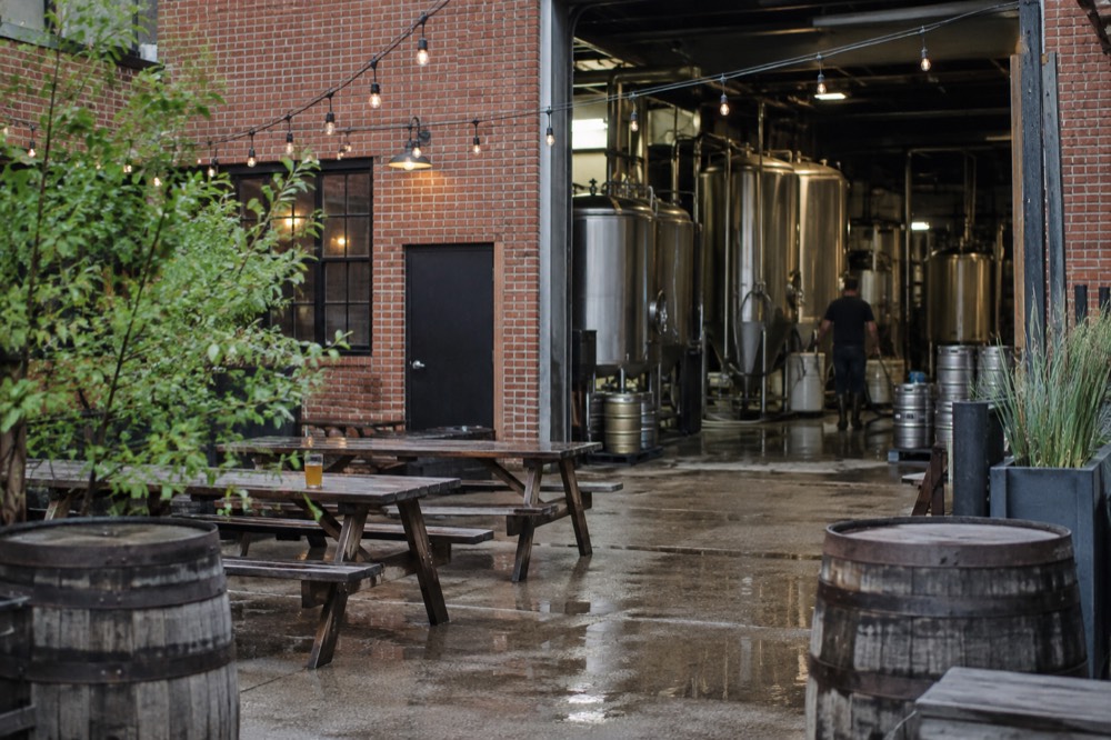 Brewing kettles and stainless steel tanks inside a small craft brewery