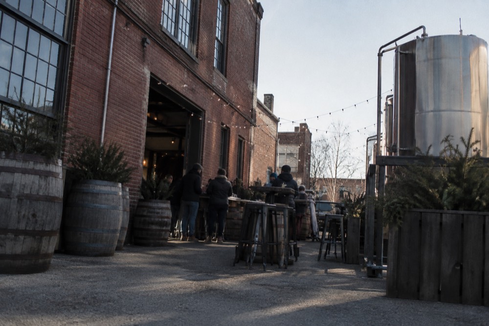 A small group sampling food at a counter in Boston's North End neighborhood