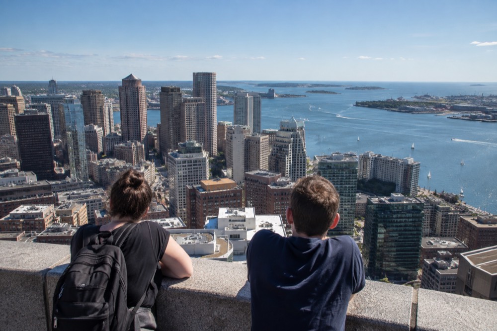 Downtown Boston towers and the harbor seen from a high observation deck on a clear day