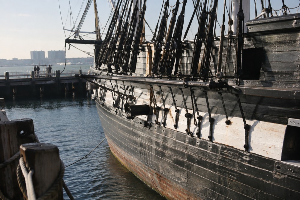 The white oak and live oak hull of the USS Constitution seen from the pier
