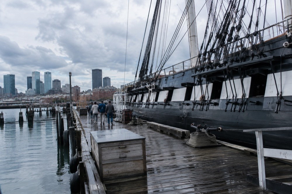 Visitors reading exhibits inside the USS Constitution Museum in a historic shipyard building