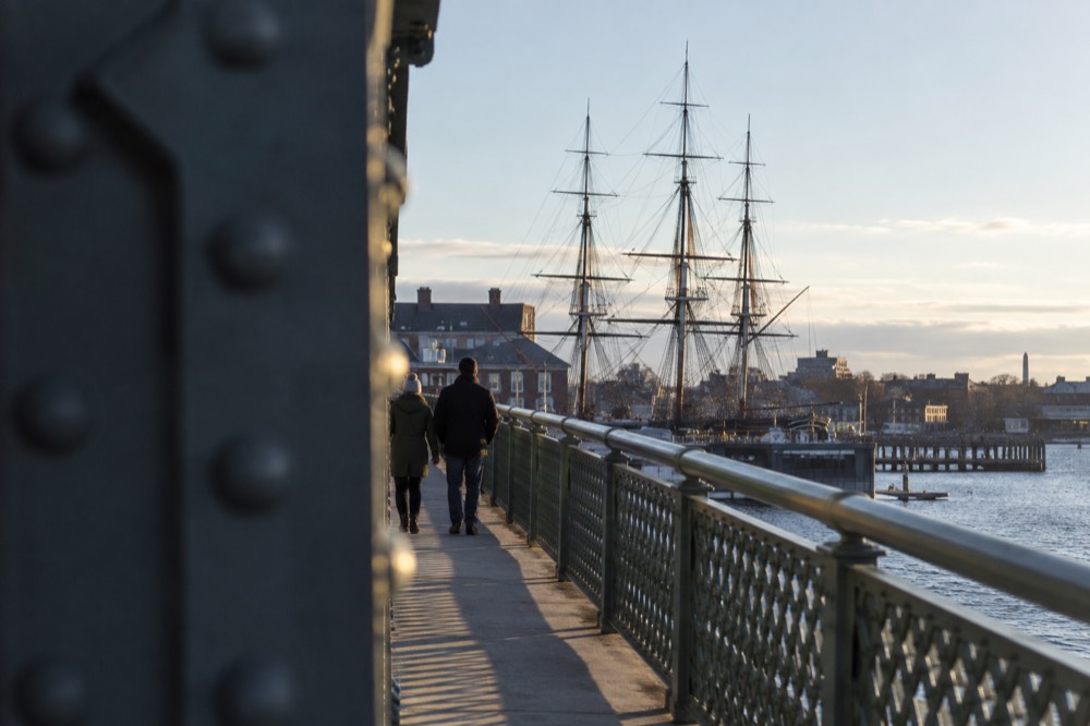 The Charlestown Bridge walkway with the USS Constitution's masts visible ahead