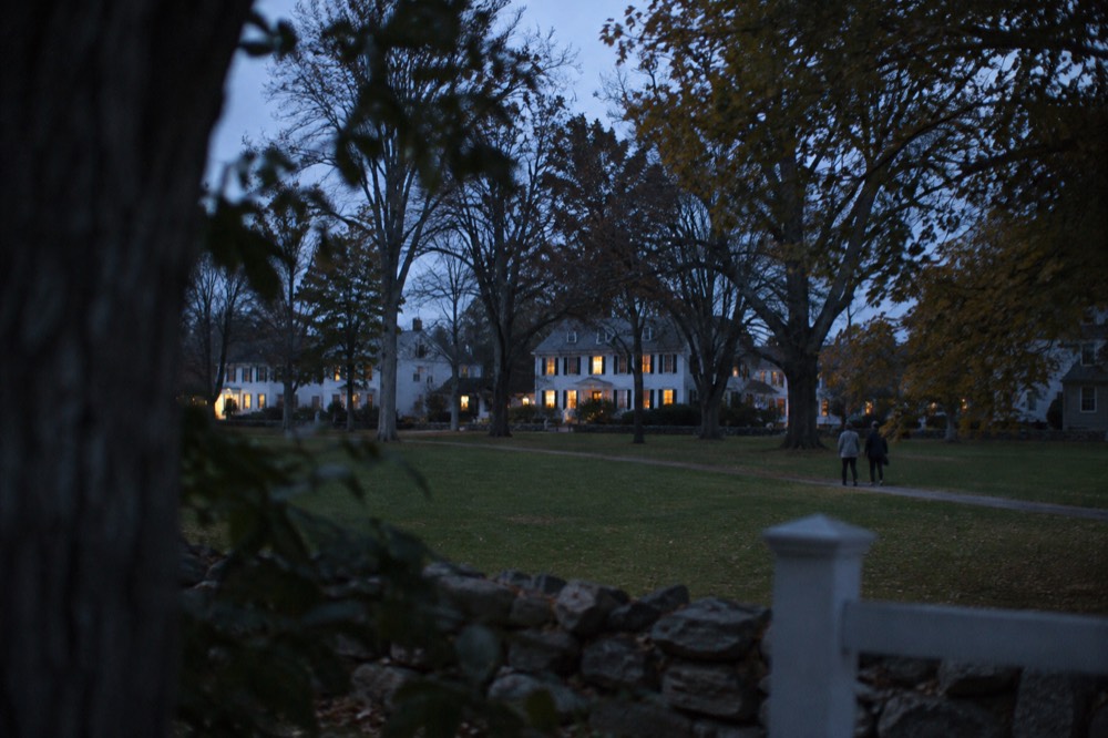 A village green surrounded by white clapboard houses and old shade trees