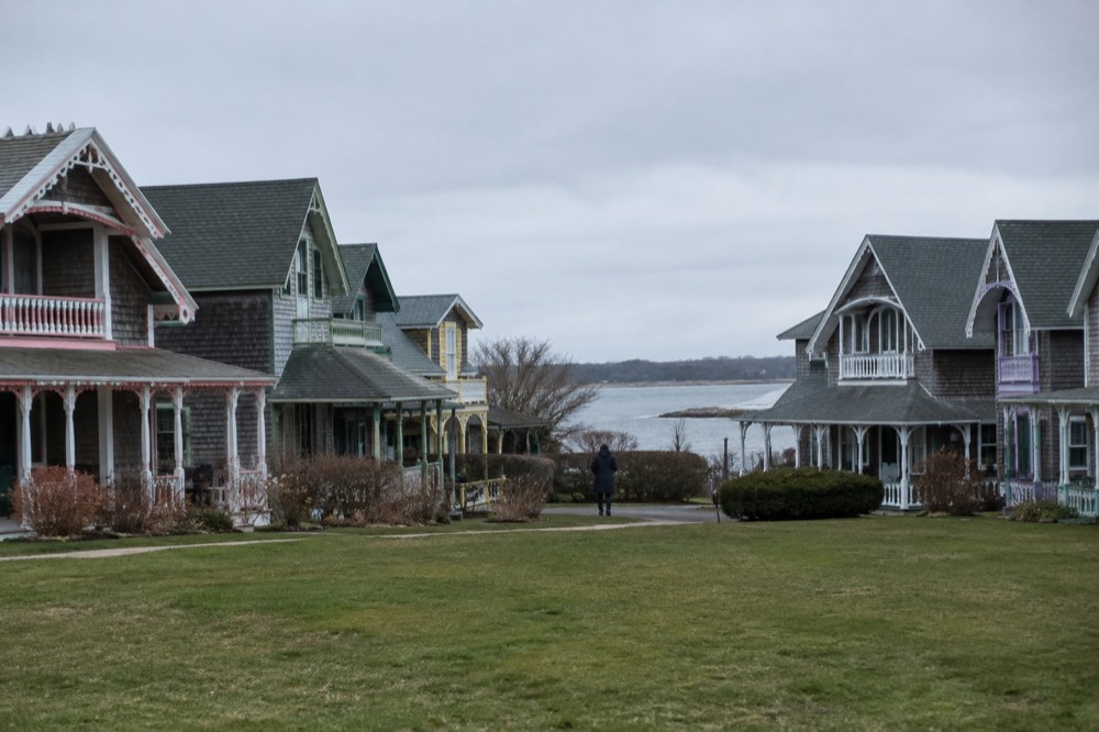 Colorful painted Victorian cottages arranged around a green in a seaside island town