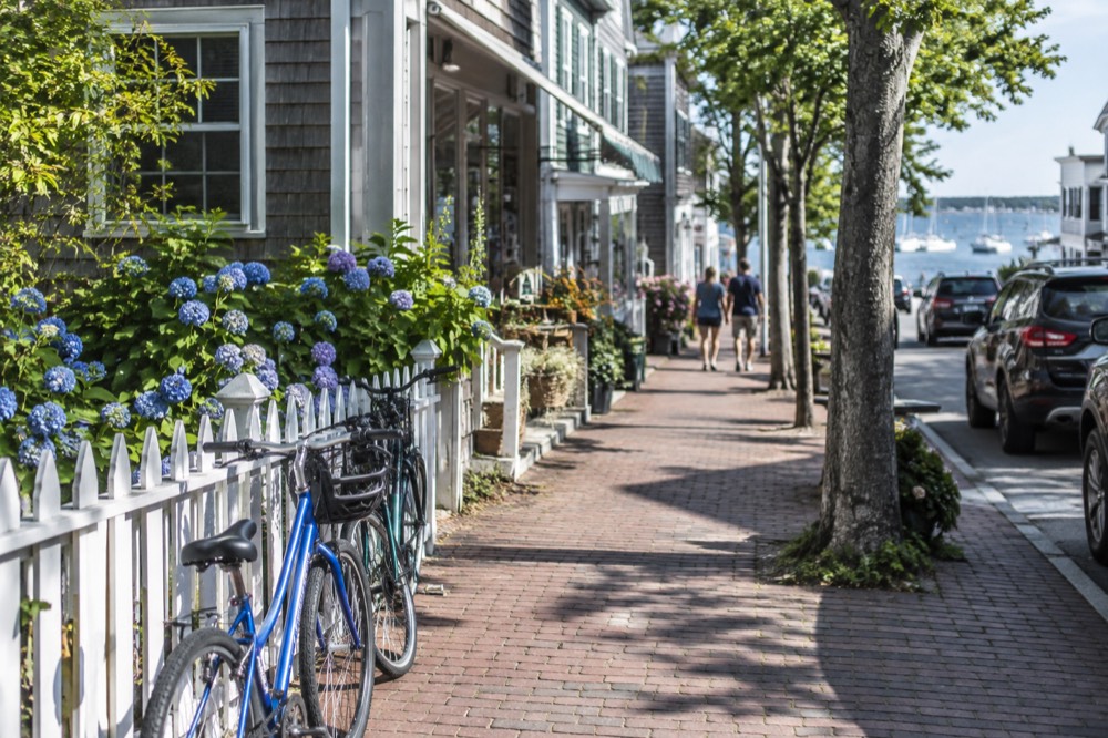 A quiet main street with shops and bicycles leaning against a fence