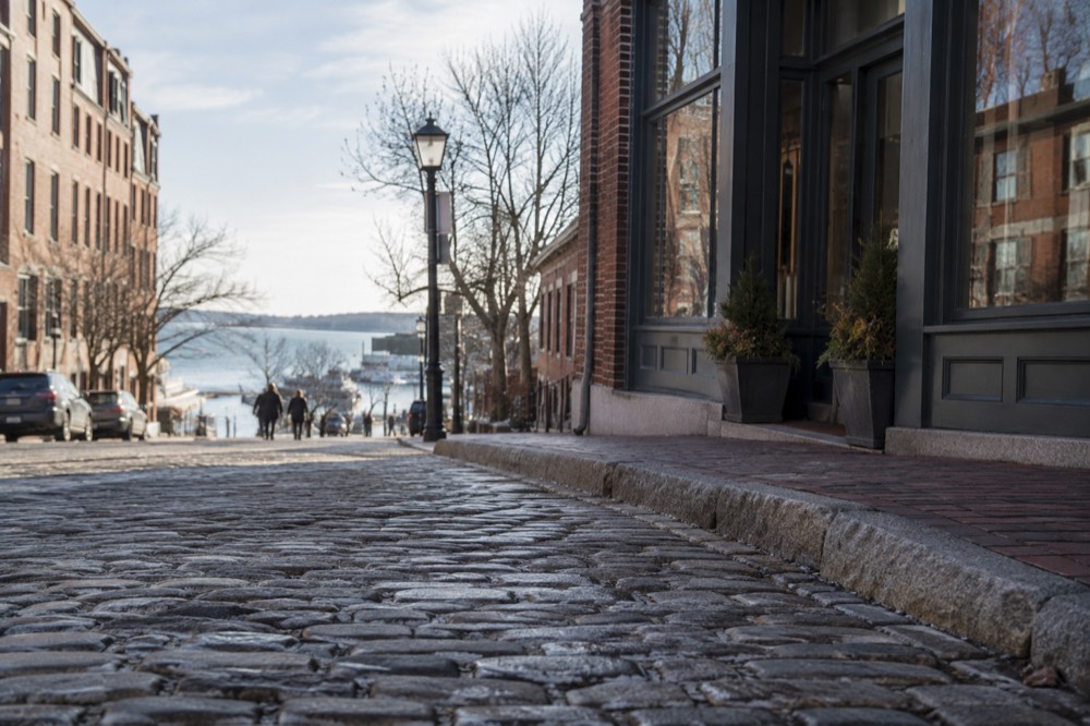 Cobblestone street in the Old Port lined with brick storefronts