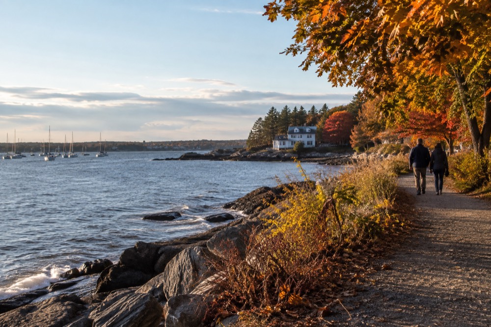 Autumn light over Casco Bay with sailboats near the shore
