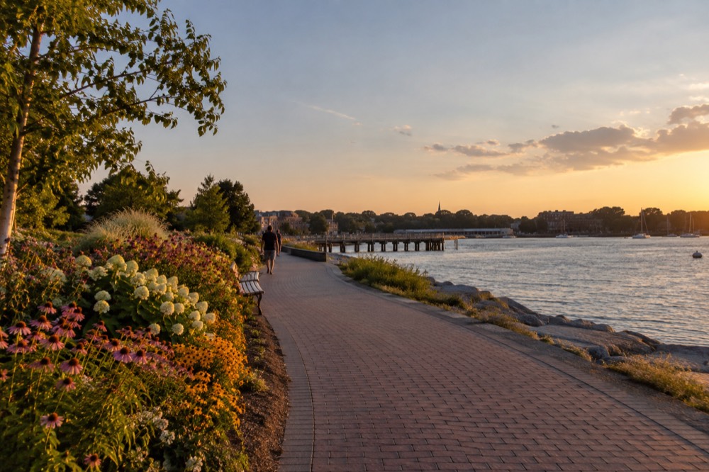 Flower gardens and a riverside walkway in a waterfront park in Portsmouth