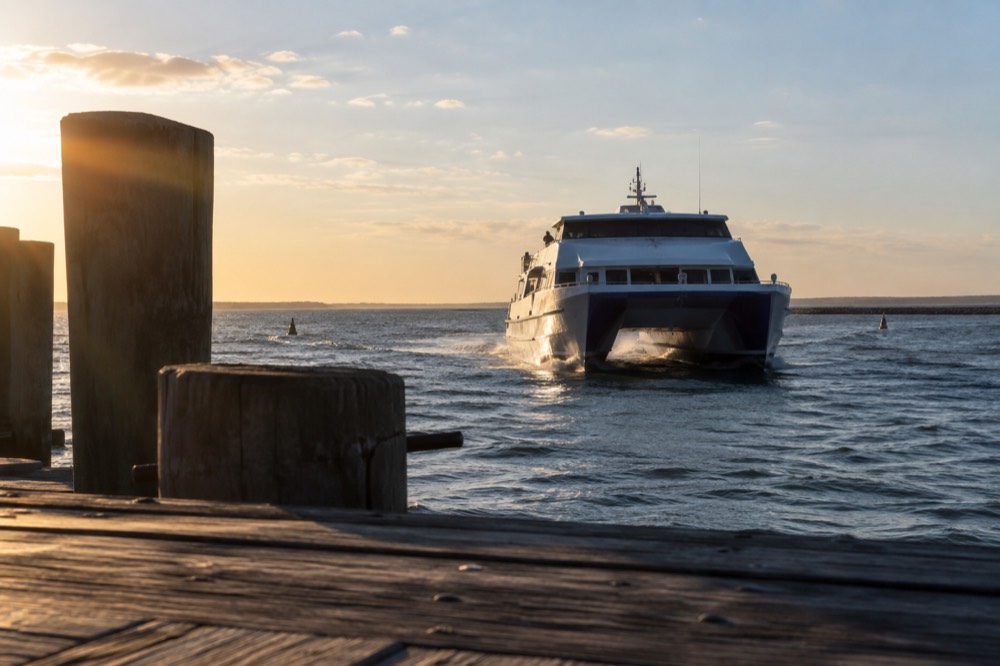 A high-speed catamaran ferry approaching MacMillan Pier in Provincetown harbor