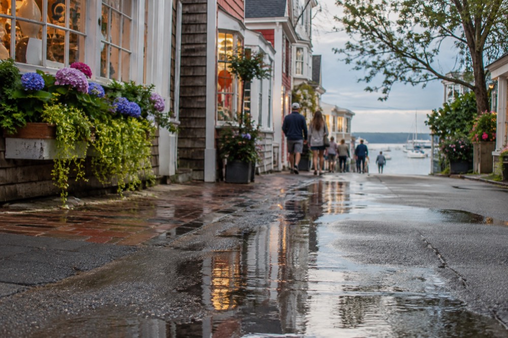 Pedestrians strolling past colorful shops and galleries on Commercial Street in Provincetown
