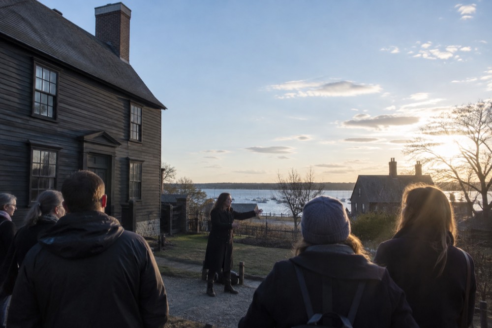 Tour guide speaking to a small group outside a historic building